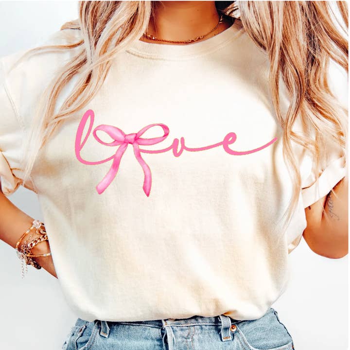 Pink Bow Love Script Valentine Tee – Feminine Ribbon Heart Graphic T-Shirt for wholesale by Top Knot Apparel
