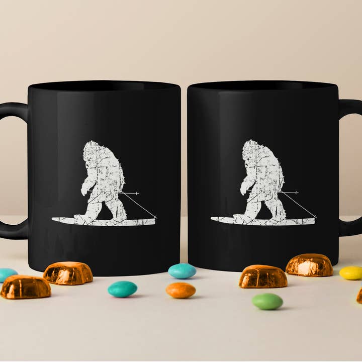 Black Big Foot Skiing Mug, Yeti Skiing Mug, Skiing Mug for wholesale on Faire