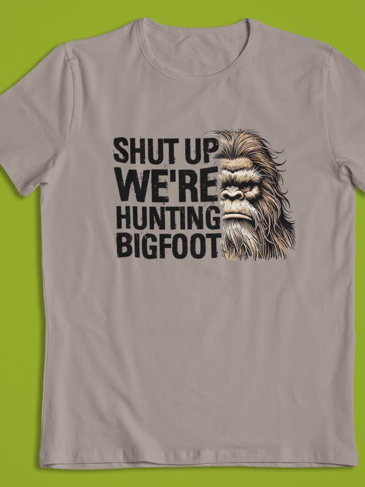 Shut Up We're Hunting Bigfoot t-shirt (Brown) for wholesale by Squatchin’ Country