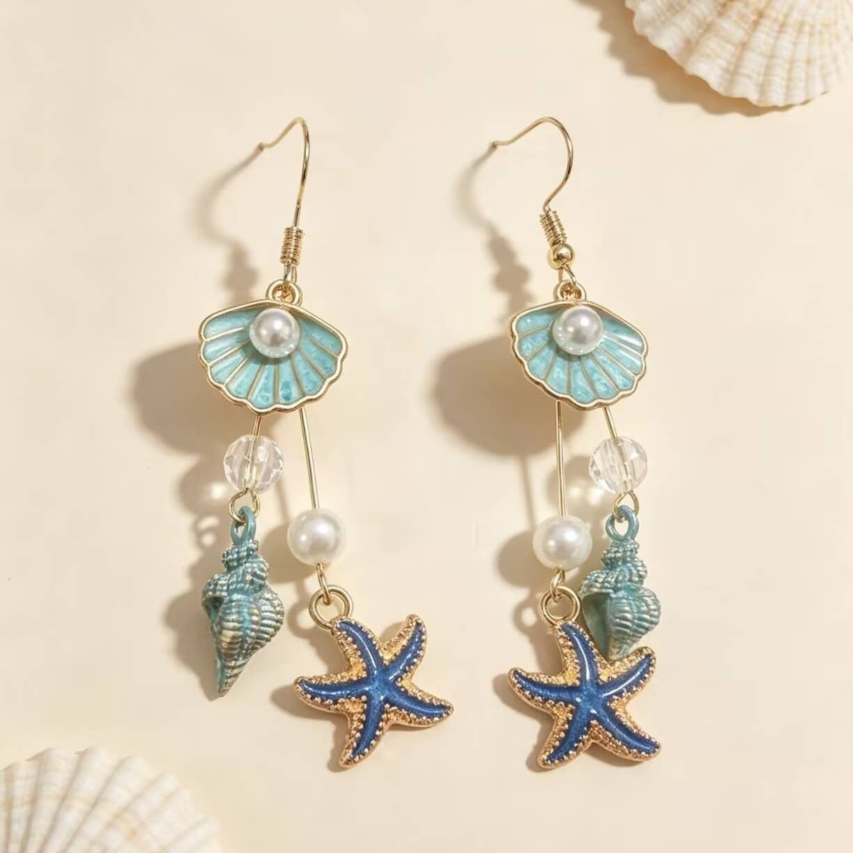 Coastal Shell Starfish Dangle Drop Earrings and other Wholesale shell jewelry for your store trending on Faire.