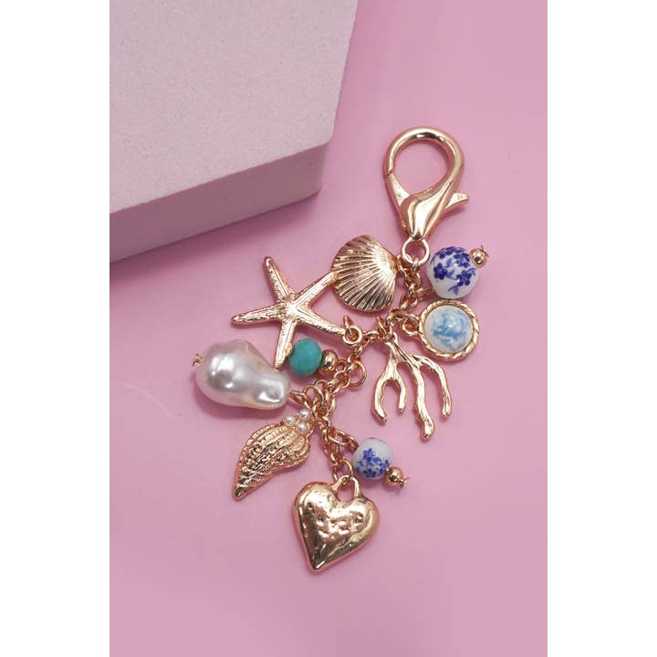 Gold PORCELAIN SEA LIFE PEARL HEART TURQ BEAD BAG CHARM | 80K009 for wholesale on Faire
