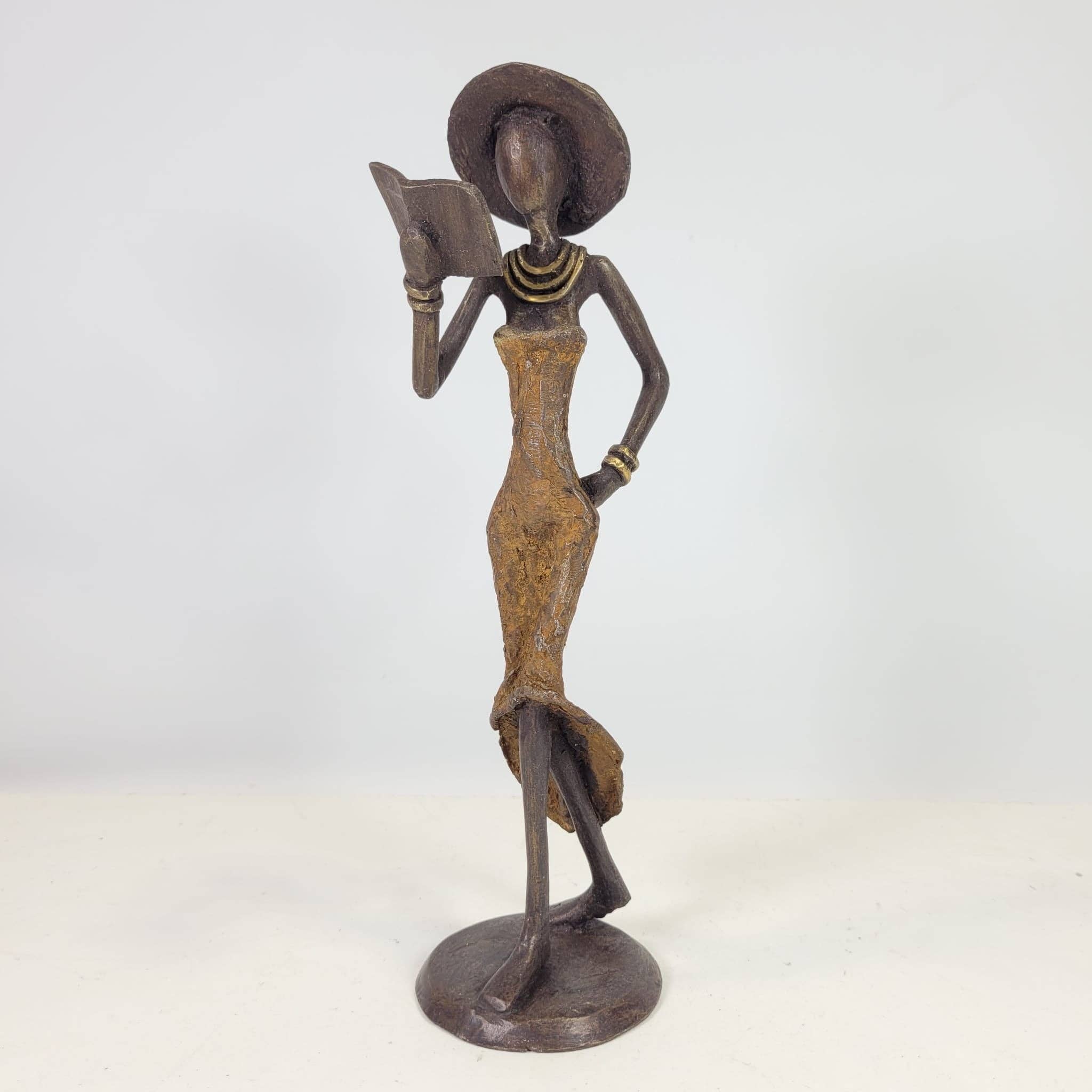 Moogoo Creative Africa - Wholesale Sculpture - Bronze sculpture “Femme avec livre et chapeau” by Soré | vers1