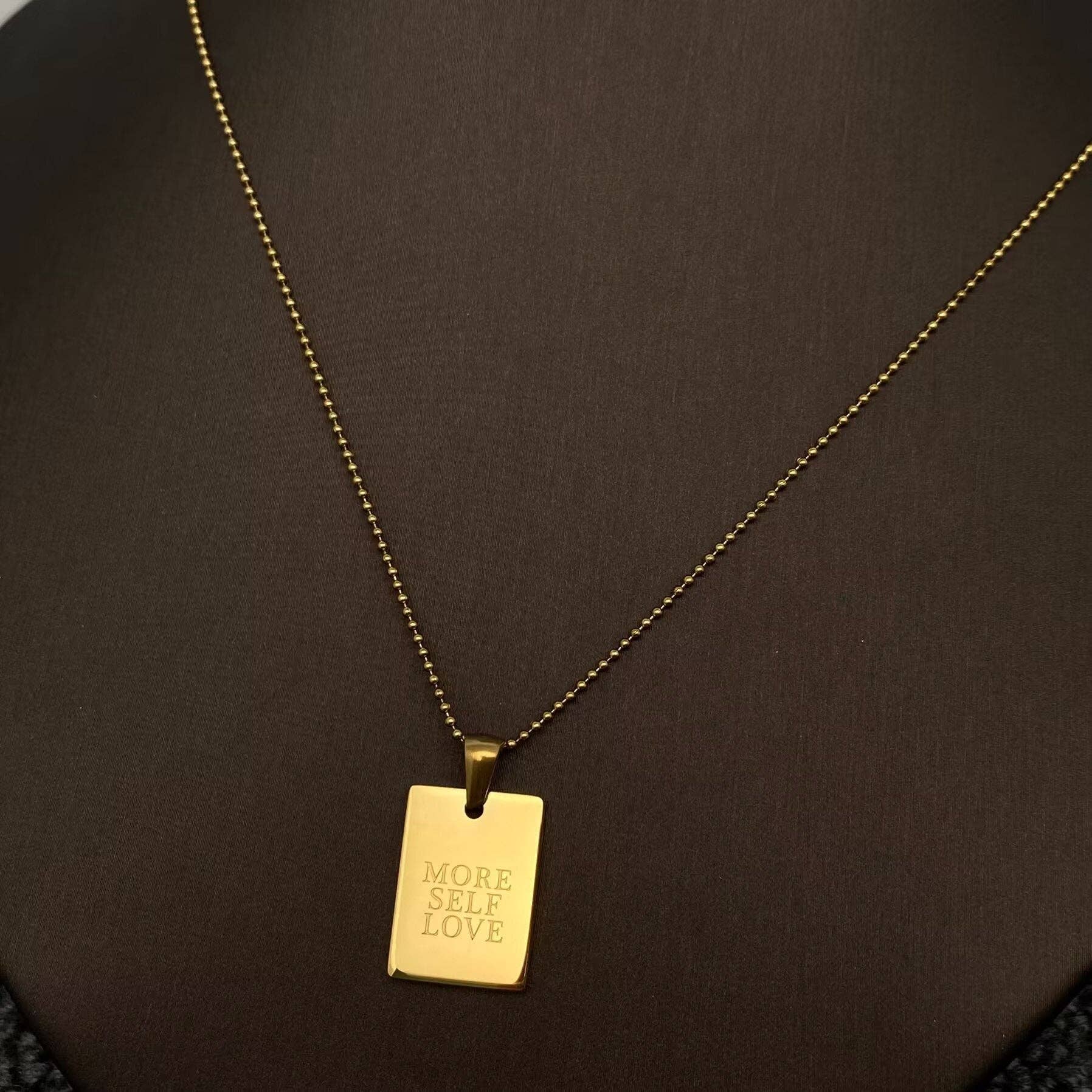 Mio Queena - Vente Colliers à pendentif - Collier en acier inoxydable plaqué or 18K avec charme carré inspirant - FGS0