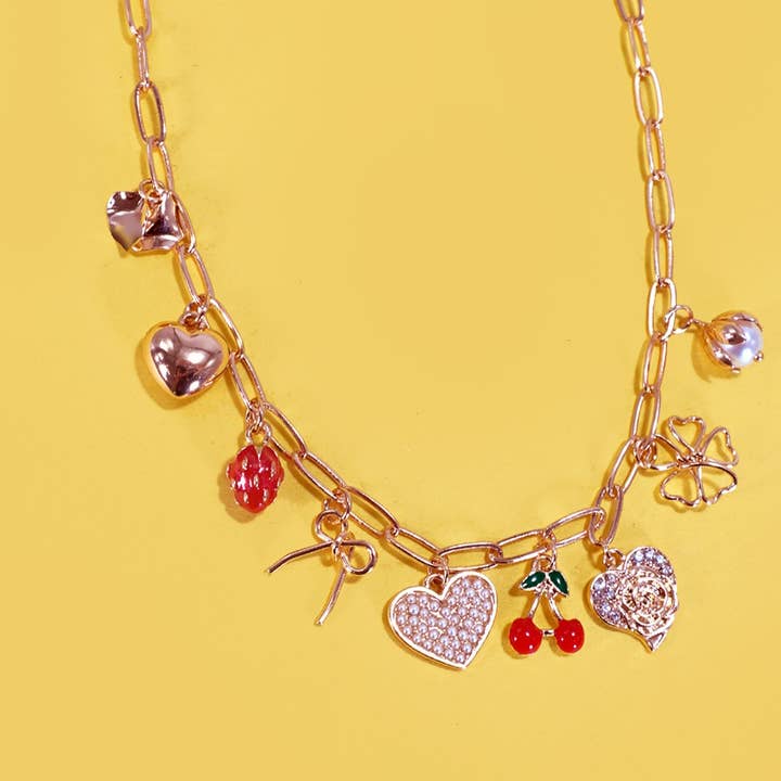 Gold MULTI CHARM BOW CHERRY HEART NECKLACE | 80N1190 for wholesale on Faire0