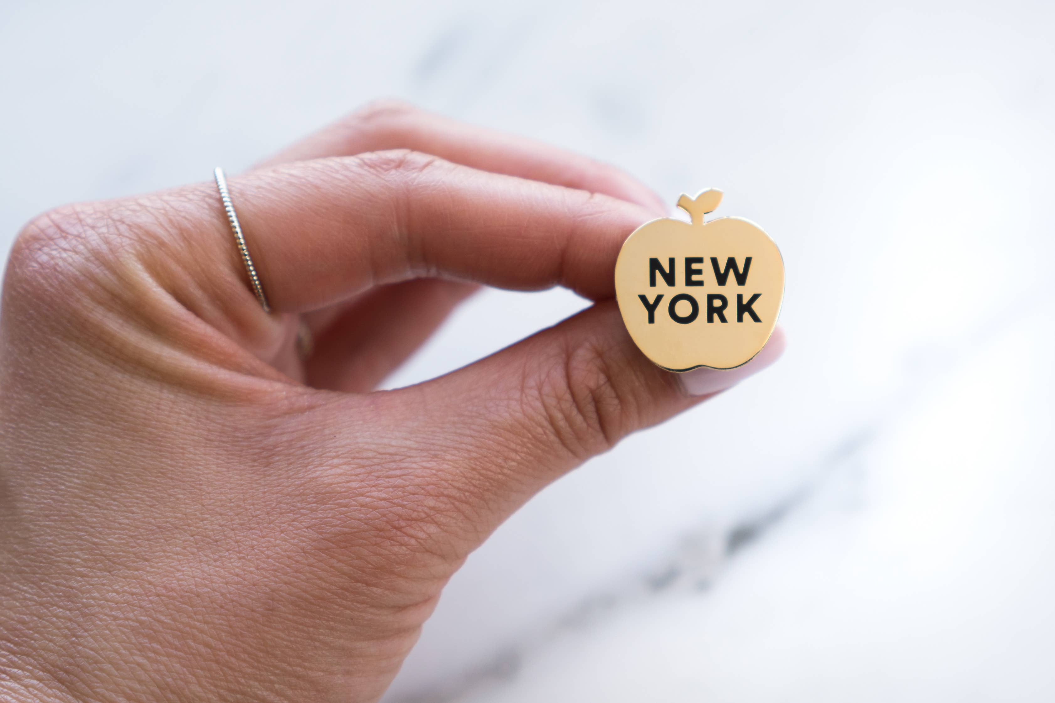 Gold black New York Apple Pin for wholesale on Faire1