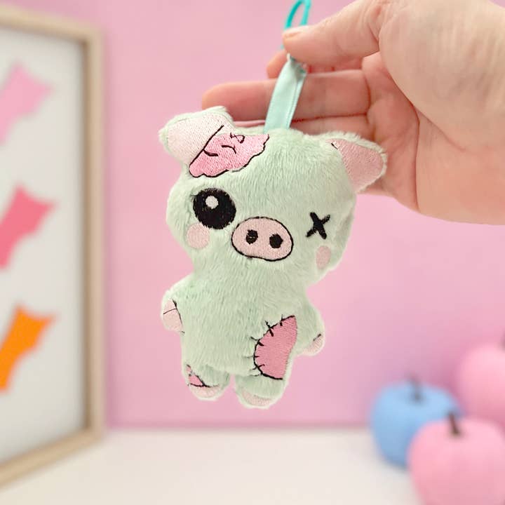 Zombie Pig Plush Bag Charm – Creepy Cute Pastel Goth Plushie for wholesale by Kawaii Hair Candy