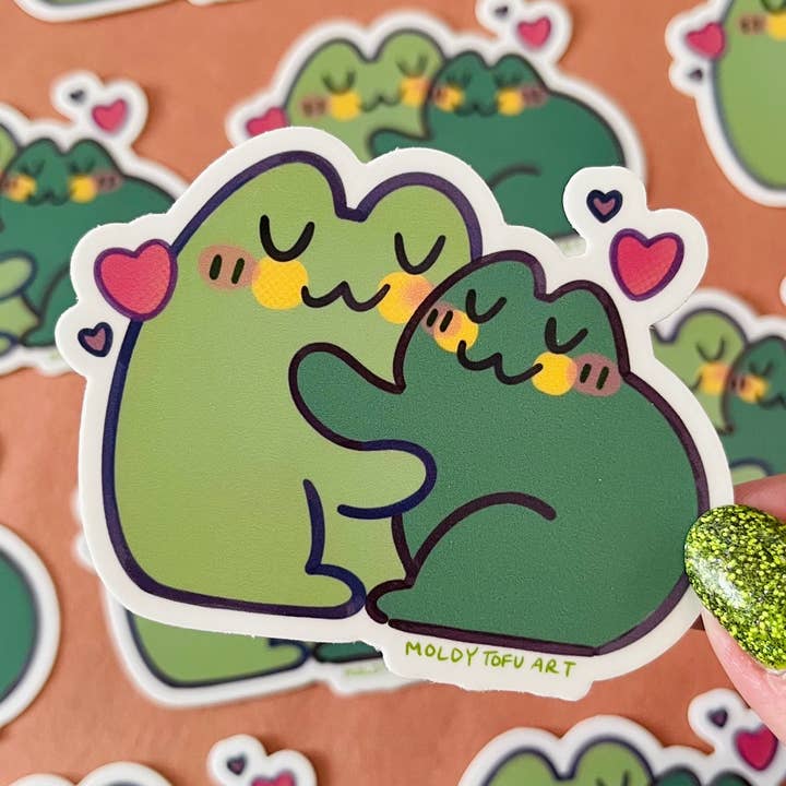Frog Hugs Vinyl Sticker for wholesale by Moldy Tofu Art