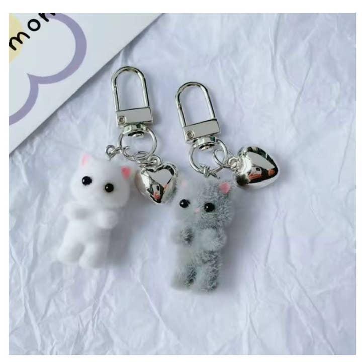 Mini Plush Cat Keychain with Heart Charm – Fuzzy Friends On-the-Go and other Purchase Wholesale attache porte clé. Free Returns & Net 60 Terms on Faire trending on Faire.