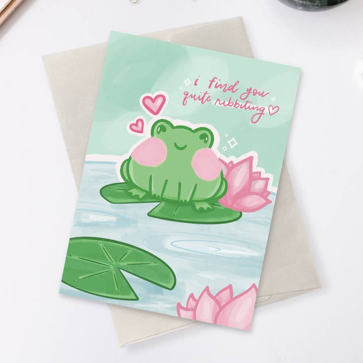 Biglietto di auguri a forma di rana con scritta «I Find You Quite Ribbing» per la vendita all'ingrosso da parte di Studio Lunaea