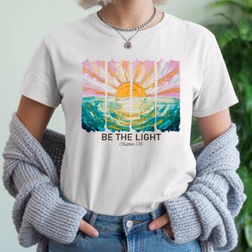 Be the Light Graphic Tee – Matthew 5:14 Faith-Inspired for wholesale by Story & Grace Co