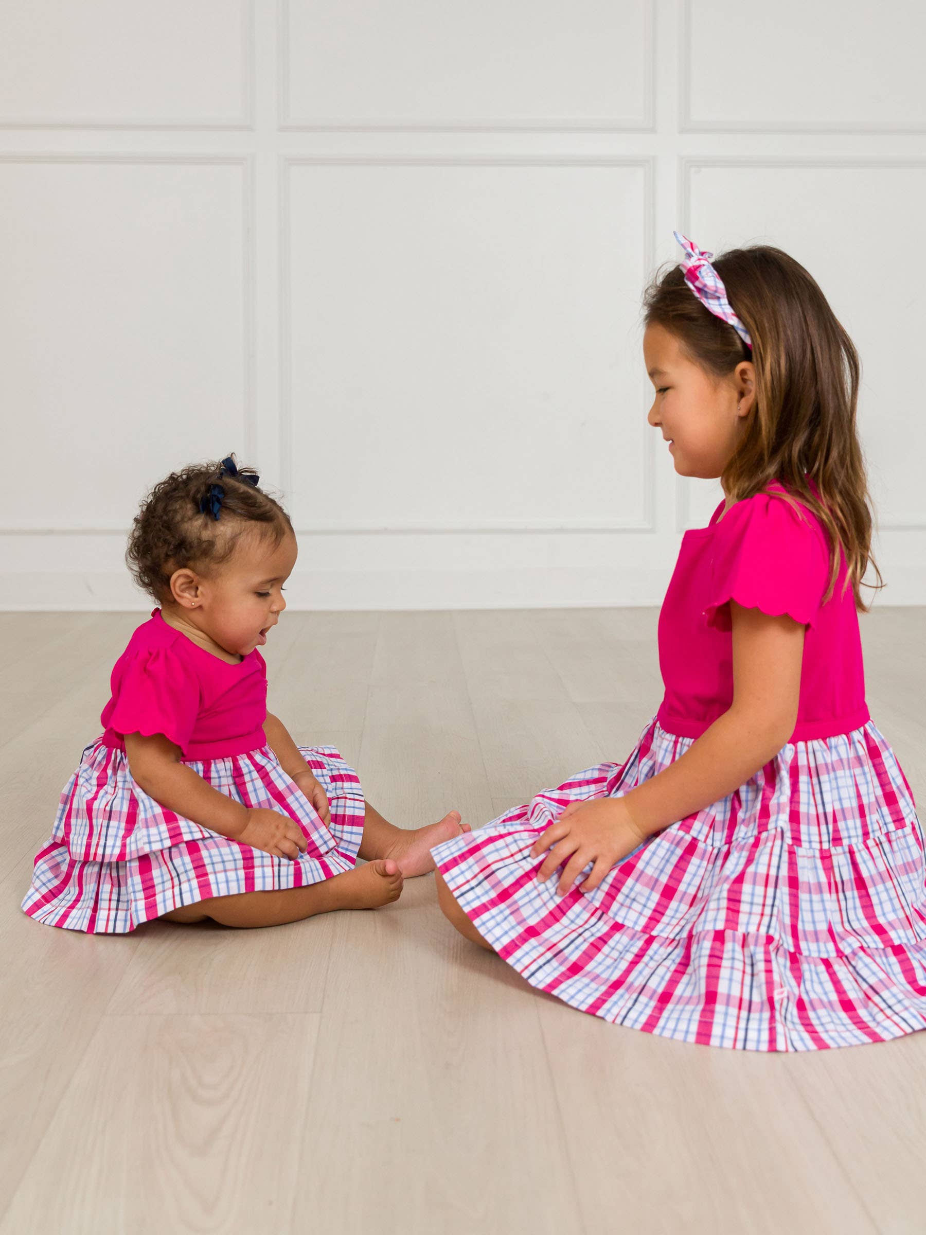 Pink Baby Girls Adley Plaid Short Sleeve Skirted Romper for wholesale on Faire2