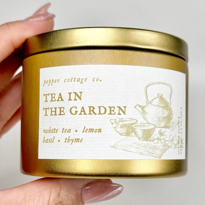 Tea in the Garden 5.5 oz Soy Candle Tin | White Tea, Lemon, Basil, Thyme | Clean Calming Herbal Scented Candle for wholesale by Pepper Cottage Co. Candles