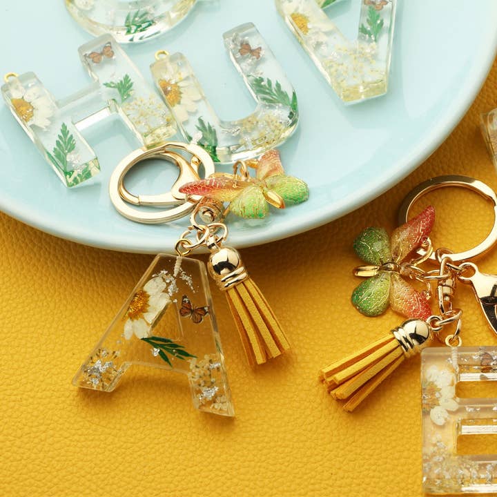Flower Letter Keychain with Yellow Butterfly Charm_CWAB5090 and other Purchase Wholesale resin letters. Free Returns & Net 60 Terms on Faire trending on Faire.