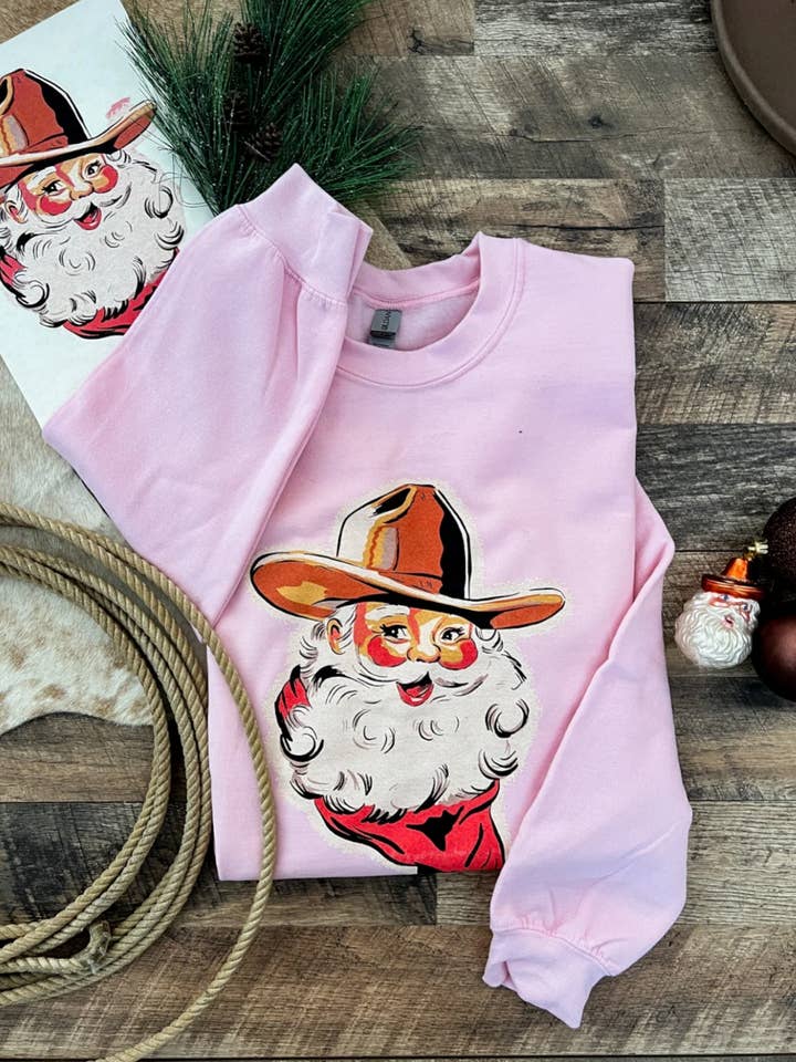 Cowboy Santa Tee or Sweatshirt(Pink) for wholesale by The Fringed Pineapple