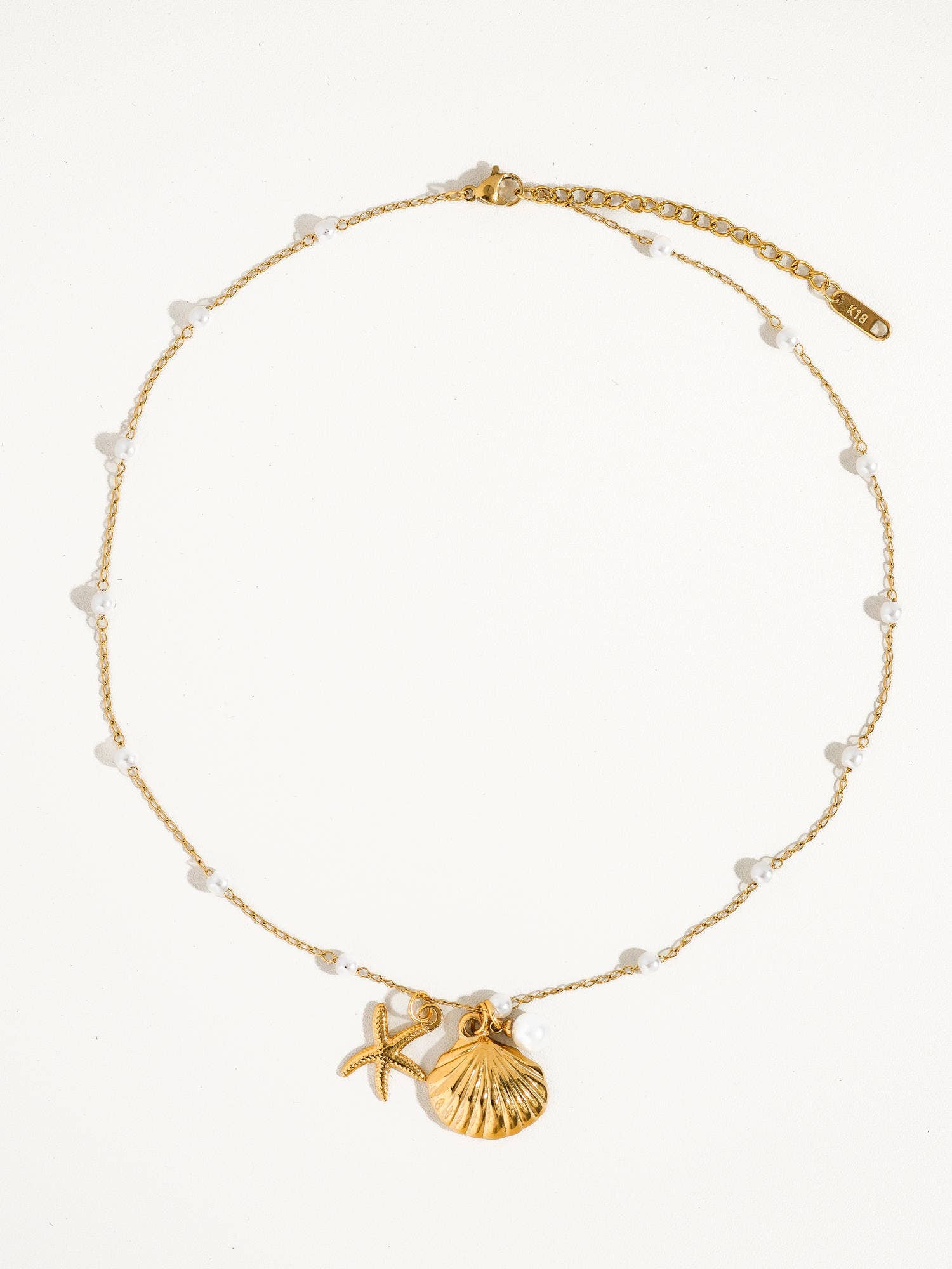 Oro Giallo Collana e bracciale con ciondoli a conchiglia e stella marina in oro 18K con perla in vendita all'ingrosso su Faire2