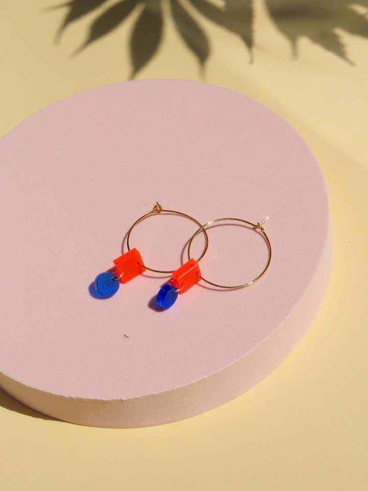 Aros de aço inox com formas geométricas azul laranja por atacado de Niemalsmehrohne