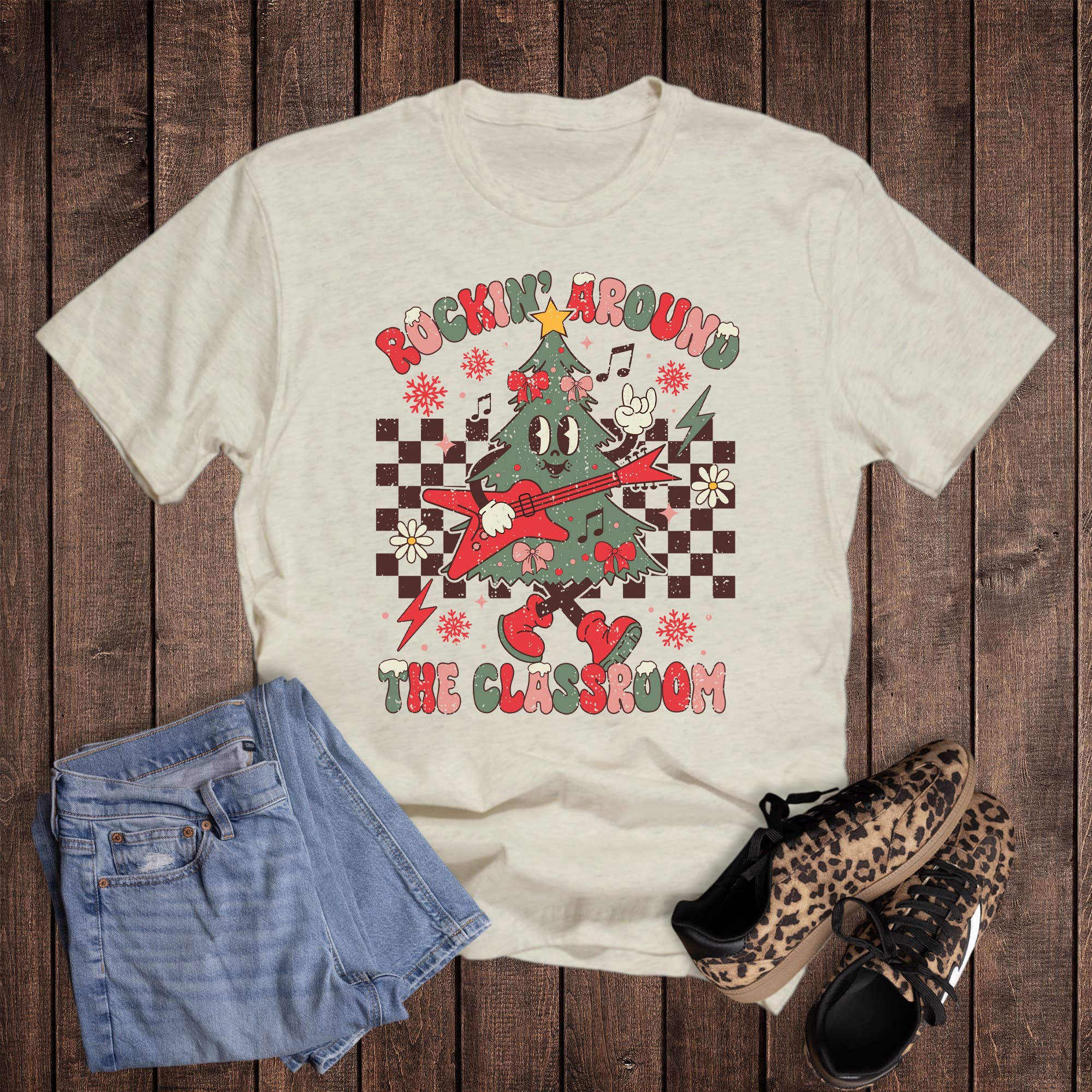 Oat Christmas Teacher Rockin' Around the Classroom Graphic Tee for wholesale on Faire0