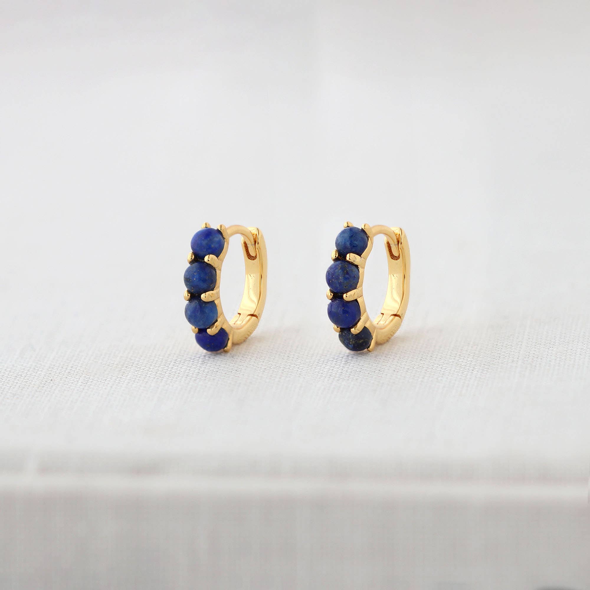 Kris Nations – wholesale Huggie earrings – Blue Lapis Huggie Hoop Earrings 18K Gold Vermeil 13mm Hoops 3mm Stones Hinge Closure Nickel Free Hypoallergenic Ships from CA3
