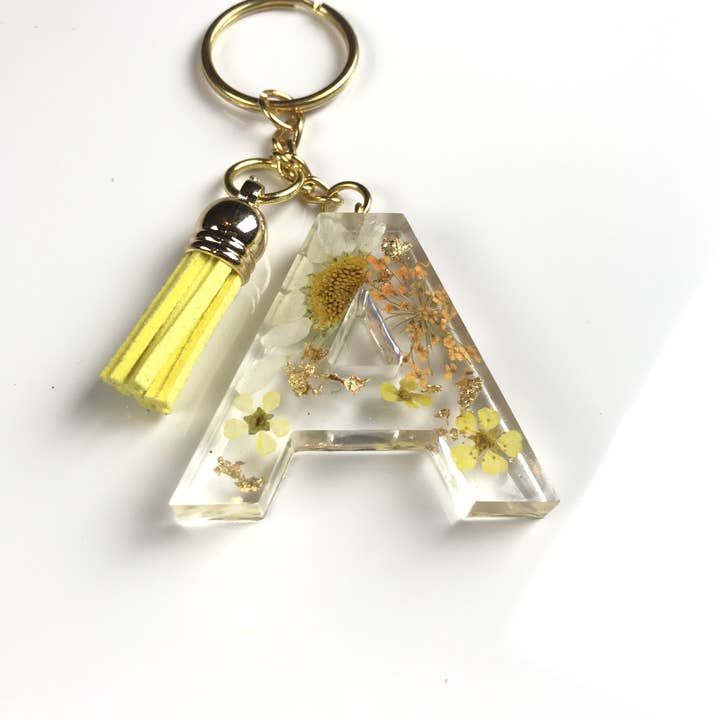 Hvid solsikke brev nøglering sæt for engroshandel hos Shop Drip Express