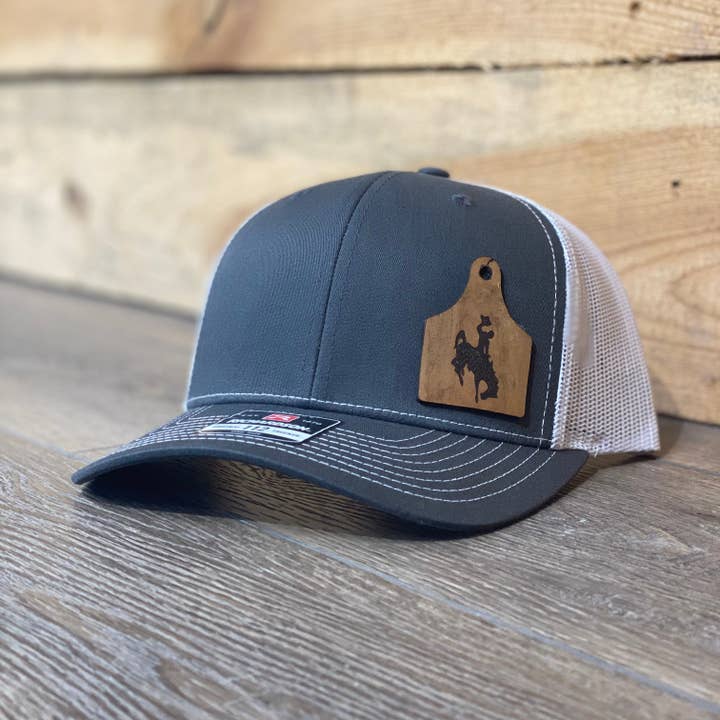 Wyoming Cowboys Leather Cow Tag Patch Charcoal Snapback Hat for wholesale by Living My Best Life in Wyoming
