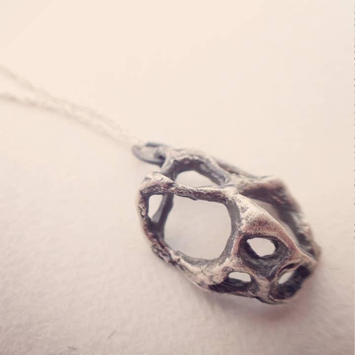 Wild honeycomb cage pendant. Oxidised silver necklace. for wholesale by Beca Beeby