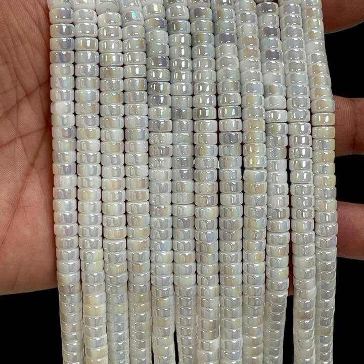 Iridescerande aura kristallpärlor vita 6x4mm heishi-skivpärlor för wholesale av TRIVENI USA INC