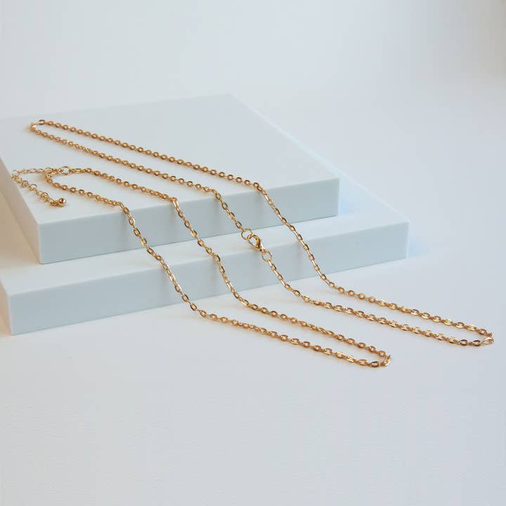 Gold Tone Base Metal Flat Oval Chain for wholesale by Charles Albert Inc