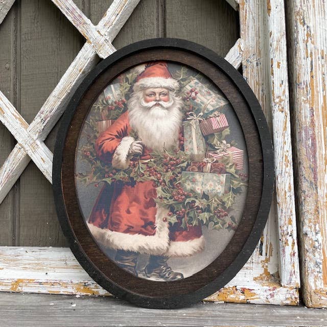 Santa w/ Holly Oval Framed Canvas Print for wholesale by LAND OF COTTON