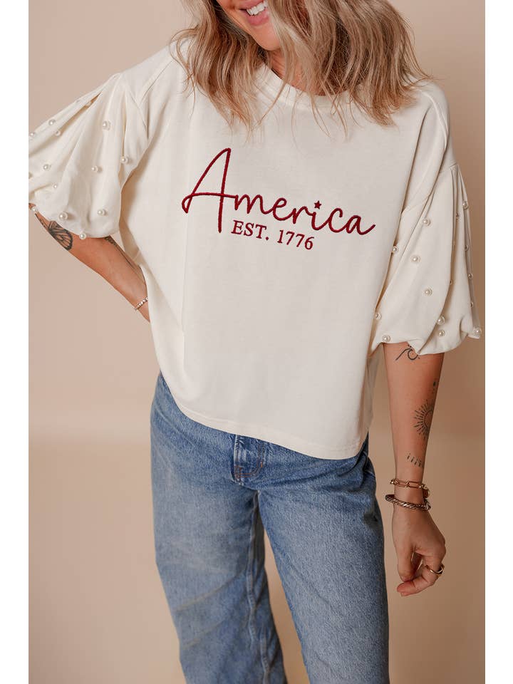 White LDC America EST 1776 Embroidered Pearl Beaded T Shirt for wholesale on Faire
