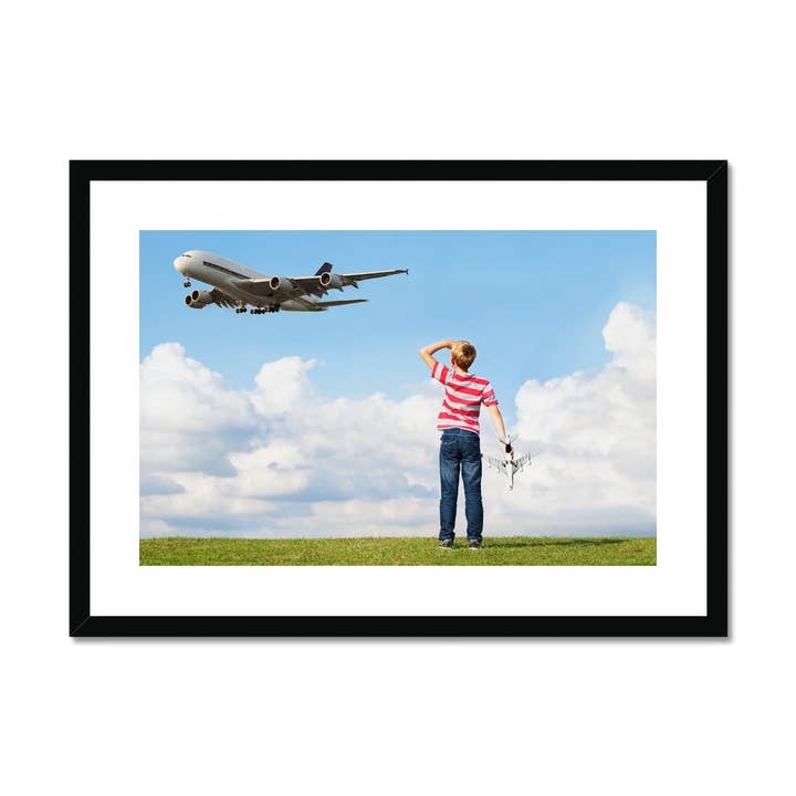 Boy watching passenger plane Framed & Mounted Print for wholesale by Sorbey