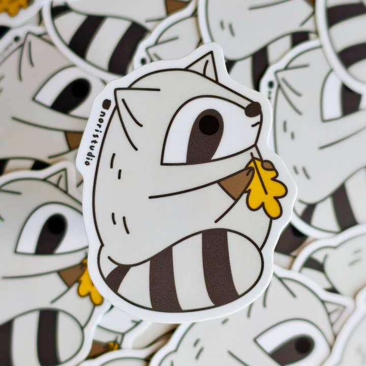 Fat Raccoon Holding Oak Leaf Vinyl Sticker for wholesale by Noristudio