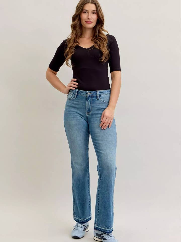 Jeans Judy Blue a vita media, taglio slim bootcut, controllo pancia, orlo sfilacciato, taglie forti. per la vendita all'ingrosso da parte di Garden Naked