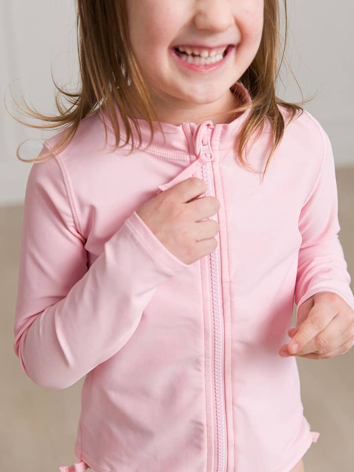 Kids Pink Long Sleeve Full Zip Rash Guard for wholesale on Faire
