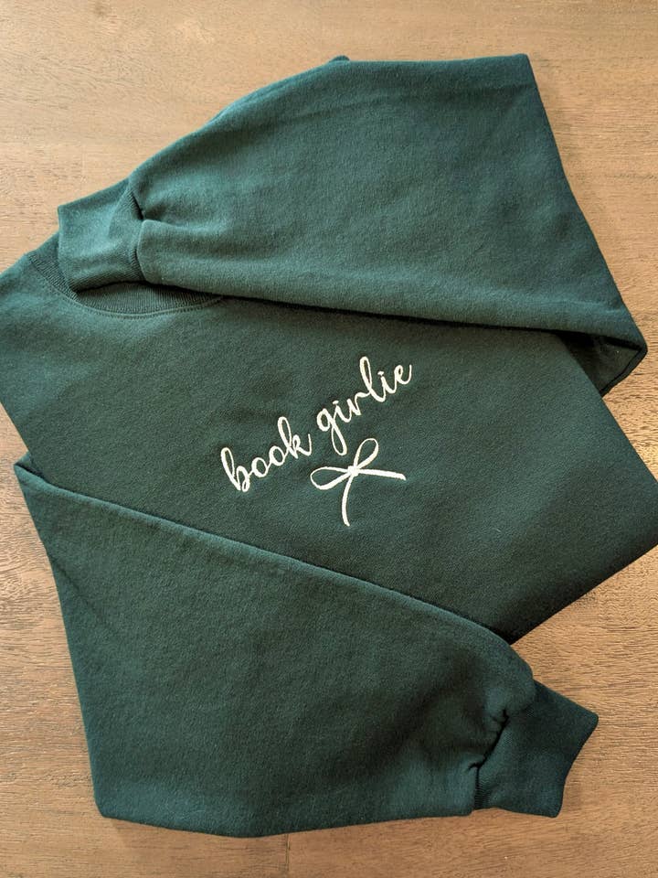 Embroidered Book Girlie and Bow Coquette Bookish Sweatshirt for wholesale by Penelope Annen Design