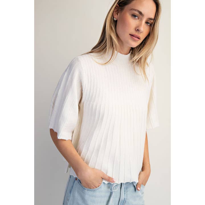 PULL À COL MONTANT MANCHES COURTES ÉVASÉ pour la vente par COTIERRA