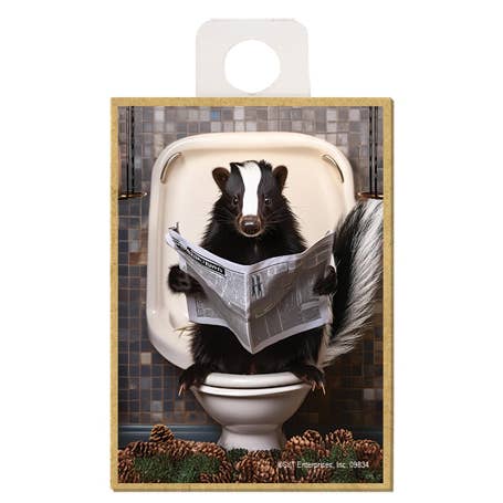 SJT Enterprises, Inc. – wholesale Magnet – Skunk - sitting on the toilet reading a newspaper magnet