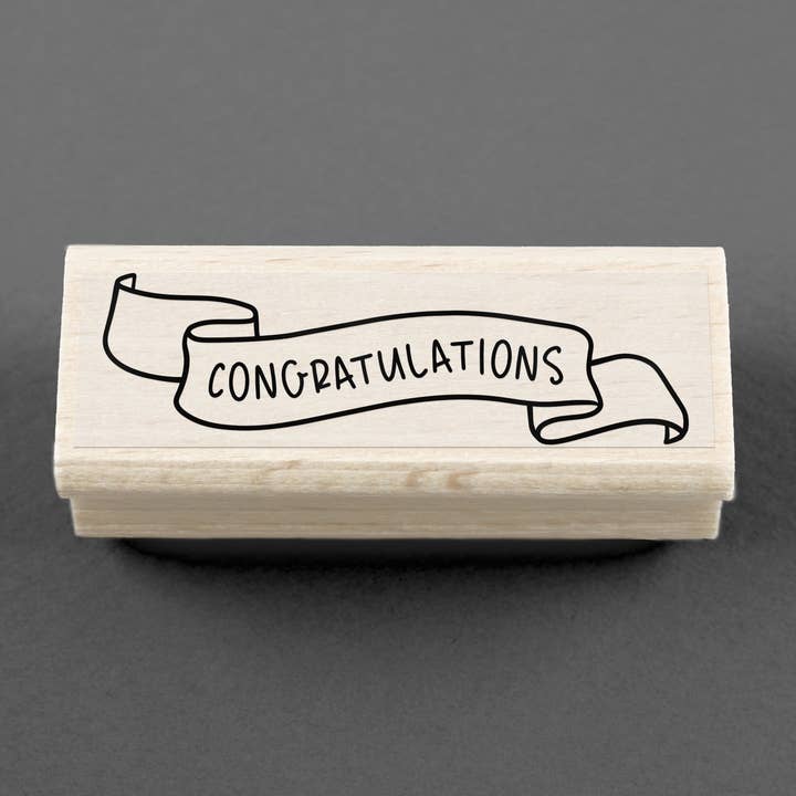 Timbro Congratulazioni Banner 80 x 25 mm per la vendita all'ingrosso da parte di Merry and Bright