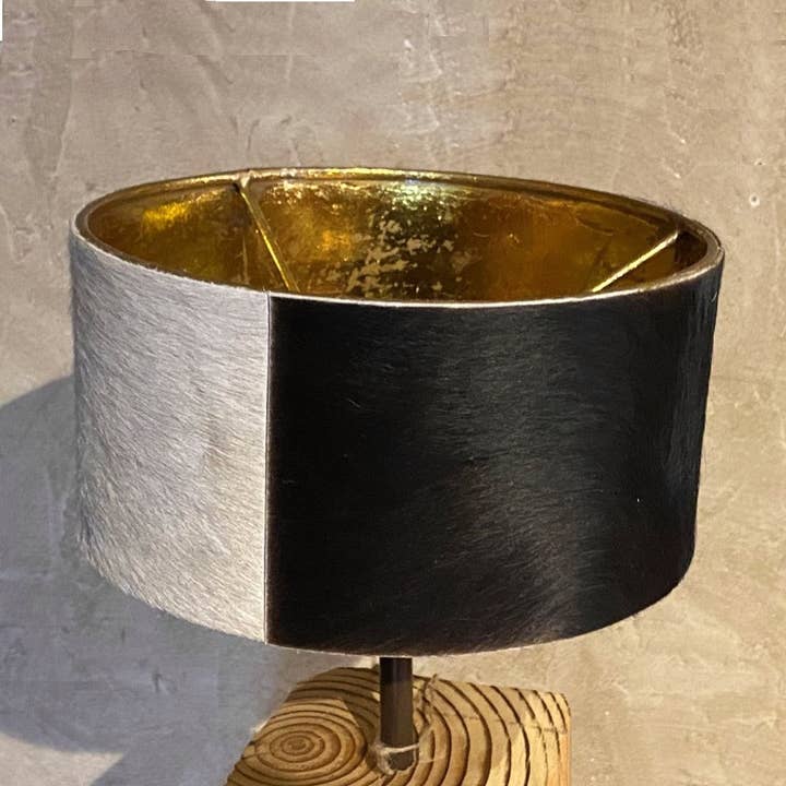 Round lamp shade in metal and cowhide for wholesale by LES SCULPTEURS DU LAC