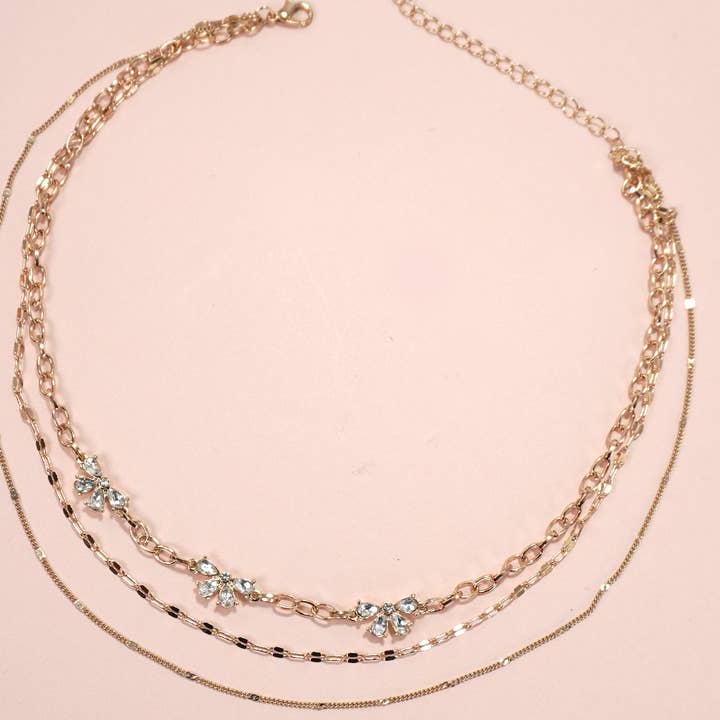 GOLD MULTI LAYER RHINESTONE BOW STATION NECKLACE | 80N1080 for wholesale on Faire
