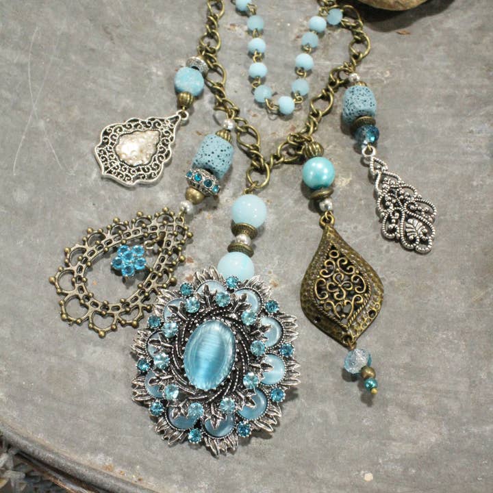 The Primitive Peddler, Inc. - Wholesale Pendant/Charm Necklace - Embellishments Of Bronze & Silver Charming Blue Pendant Layered Necklace