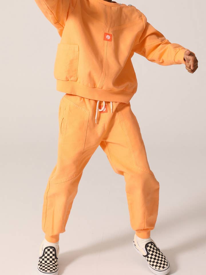 SPORTSCLUB Freizeithose aus Bio-Baumwolle in Papaya-Farbe für den Großhandel von Raquette