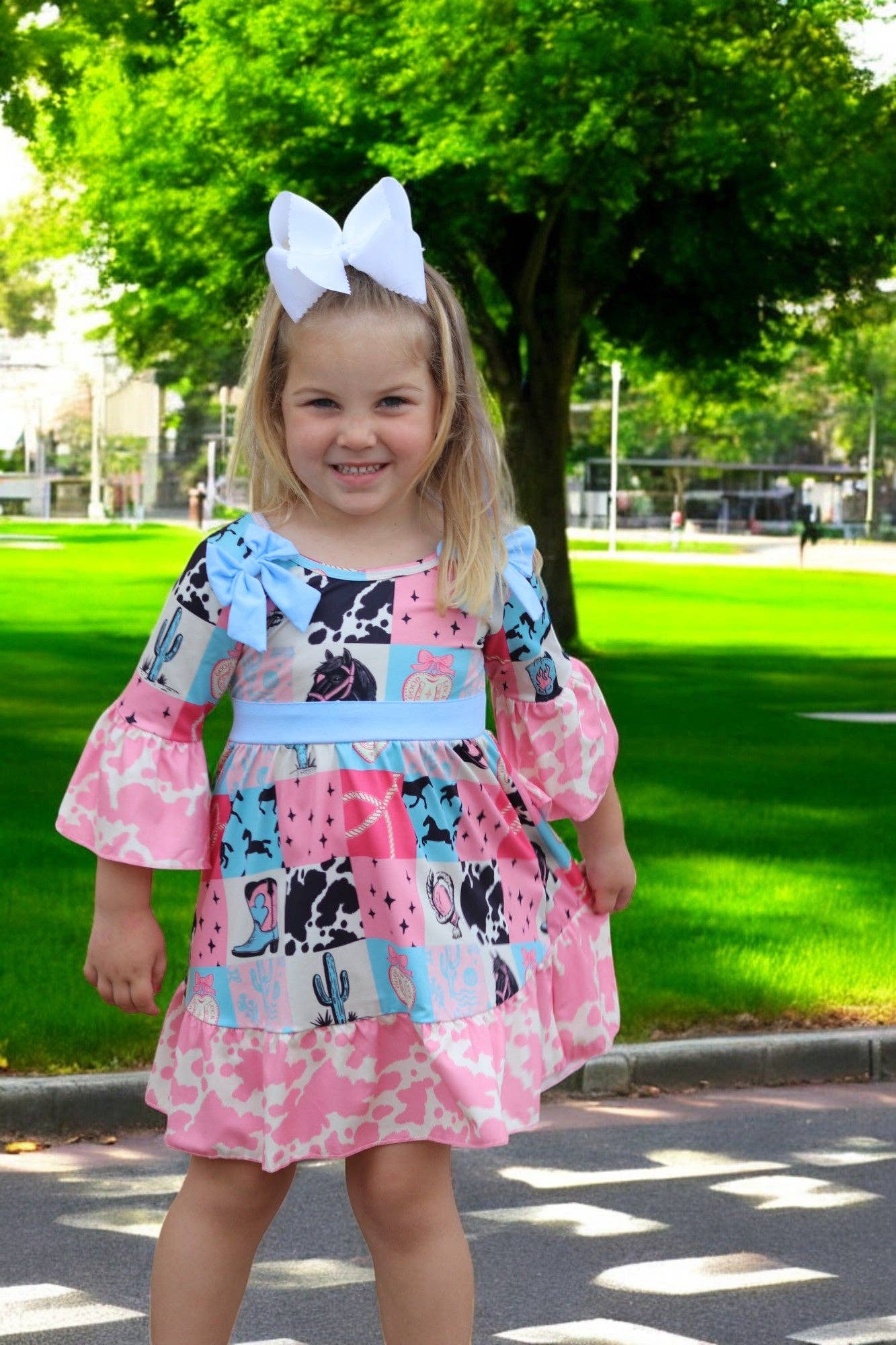 Kids Charm Online - Wholesale Dress - Kids - Beautiful wester patch printed girls dress with bows and cow printed hem.1