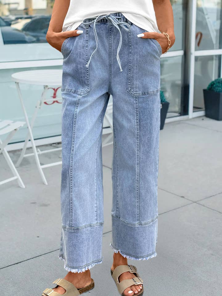 Pantalon en denim à jambes larges avec cordon de serrage, détail de couture et ourlet brut pour la vente par 66DISCO