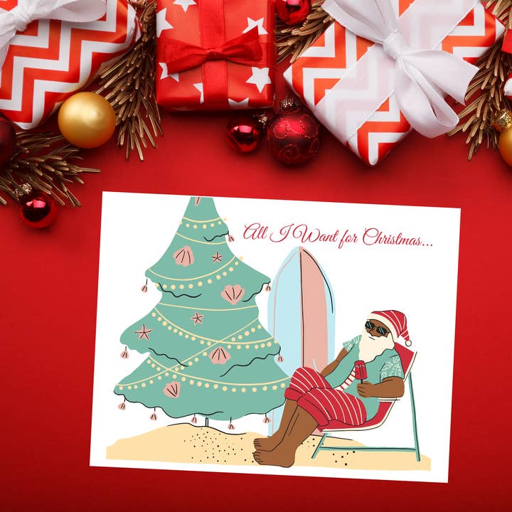 Black Santa on Beach holiday cards for wholesale by Infectious Design Co.