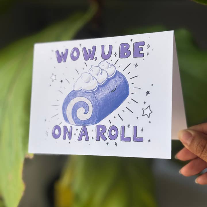 Claudine Castro Art - Wholesale Congratulations Card - Ube Cake U Be On A Roll Congratulations Blank Greeting Card