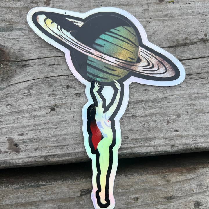 Nude Goddess holds up Planet Saturn Hologram Sticker for wholesale by Beeswag Creations