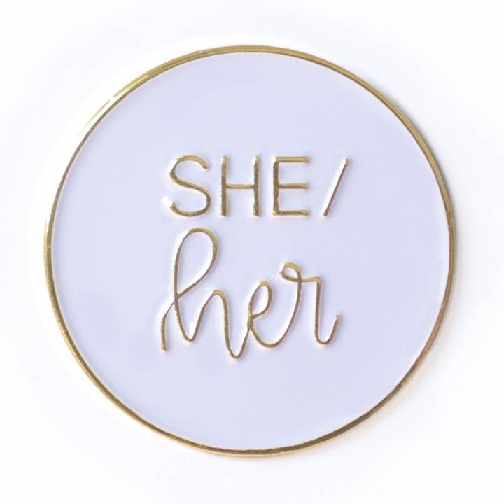 She/Her Round Pronoun Pin for wholesale by Rising Violet Press