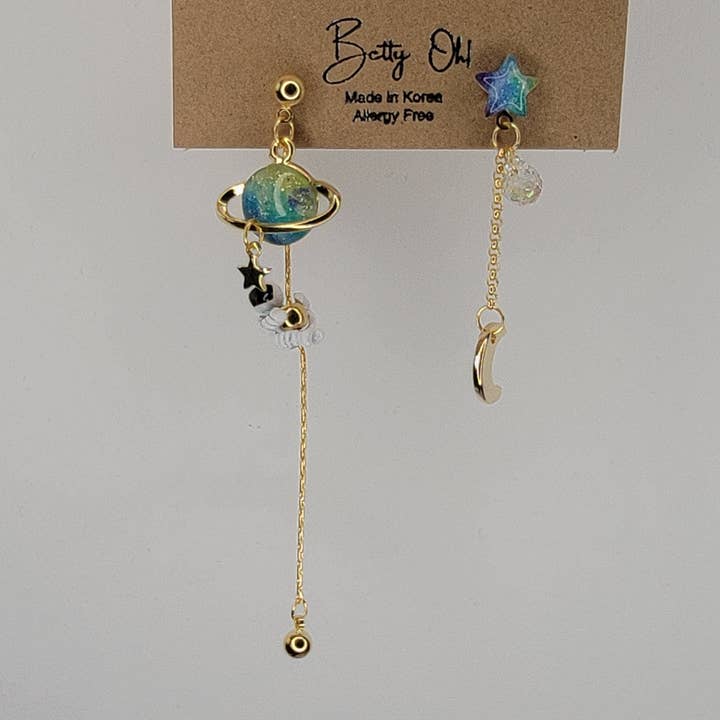 ASTRONAUT EARTH MOON AND STAR UNBALANCED DANGLE EARRINGS. for wholesale by BETTYOH INC