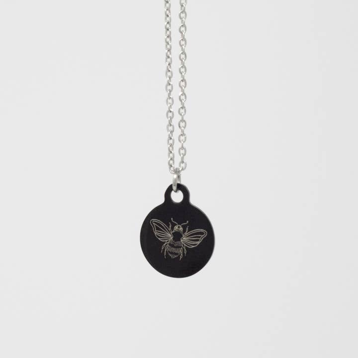 Collier en acier inoxydable noir orné d'abeilles illustrées pour la vente par Mama Peacock LLC