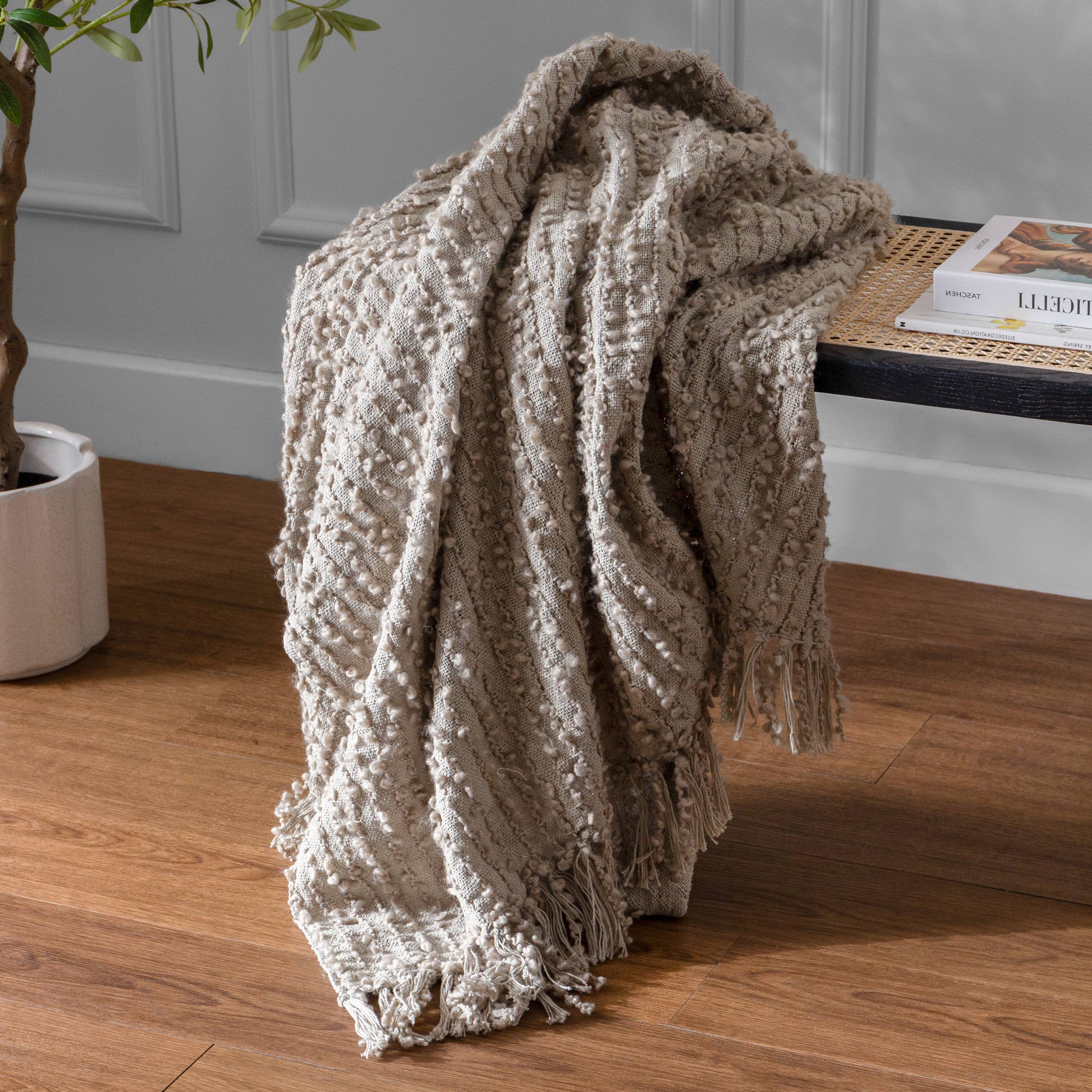 Arvo Woven Tasselled Throw Feather for wholesale on Faire0